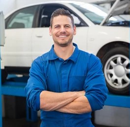 Smiling mechanic looking camera repair